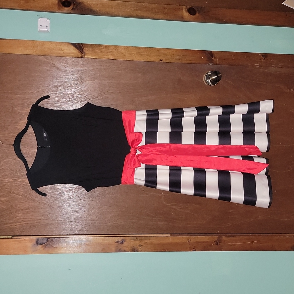 Sleeveless black and cream dress with reddish ribbon